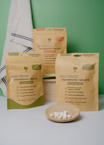 Load image into Gallery viewer, Zero Waste Toothpaste Tablets packaging with a green background
