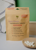Load image into Gallery viewer, Zero Waste Toothpaste Tablets packaging with tablets on a wooden plate
